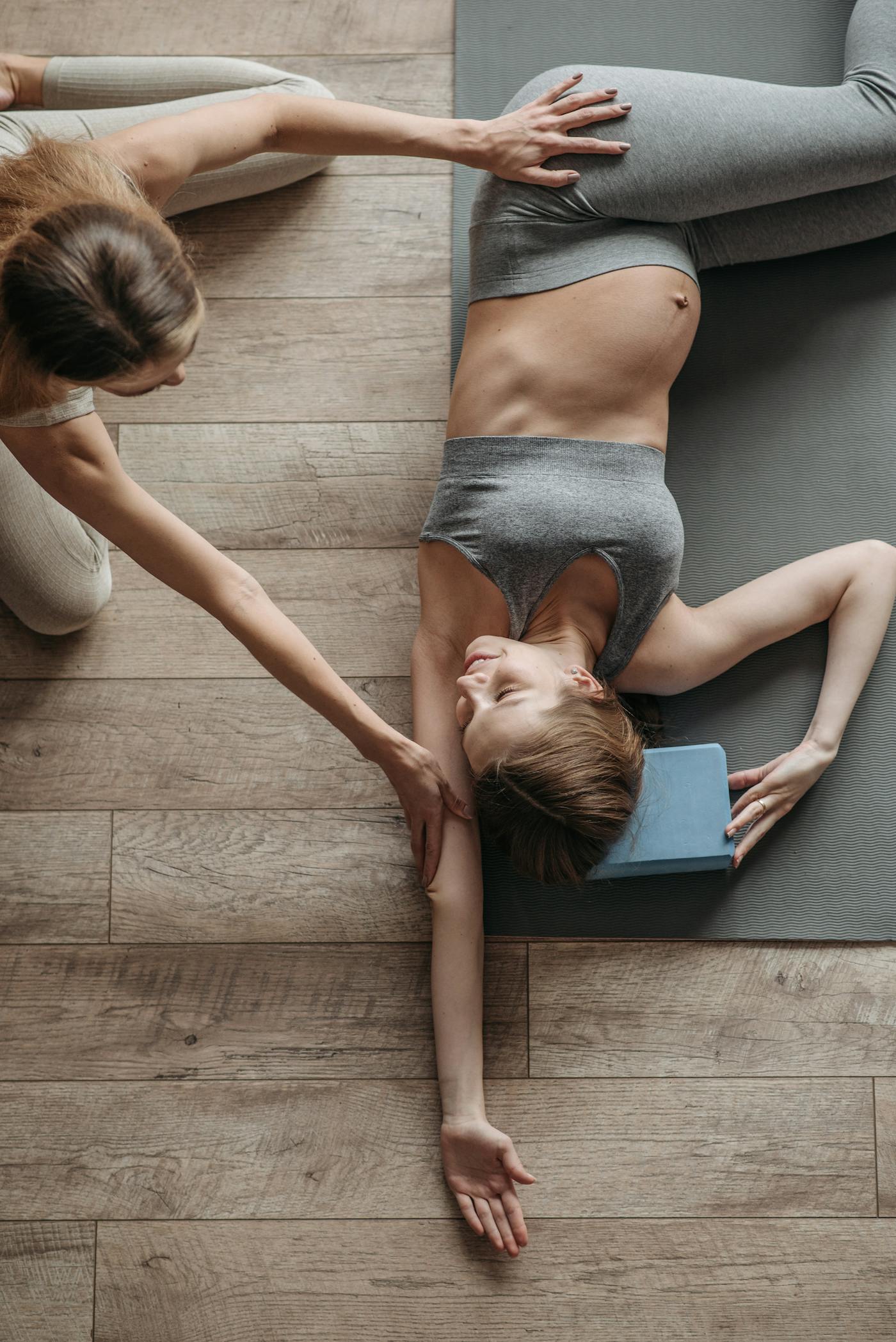 Pregnant woman receiving gentle prenatal care and stretching