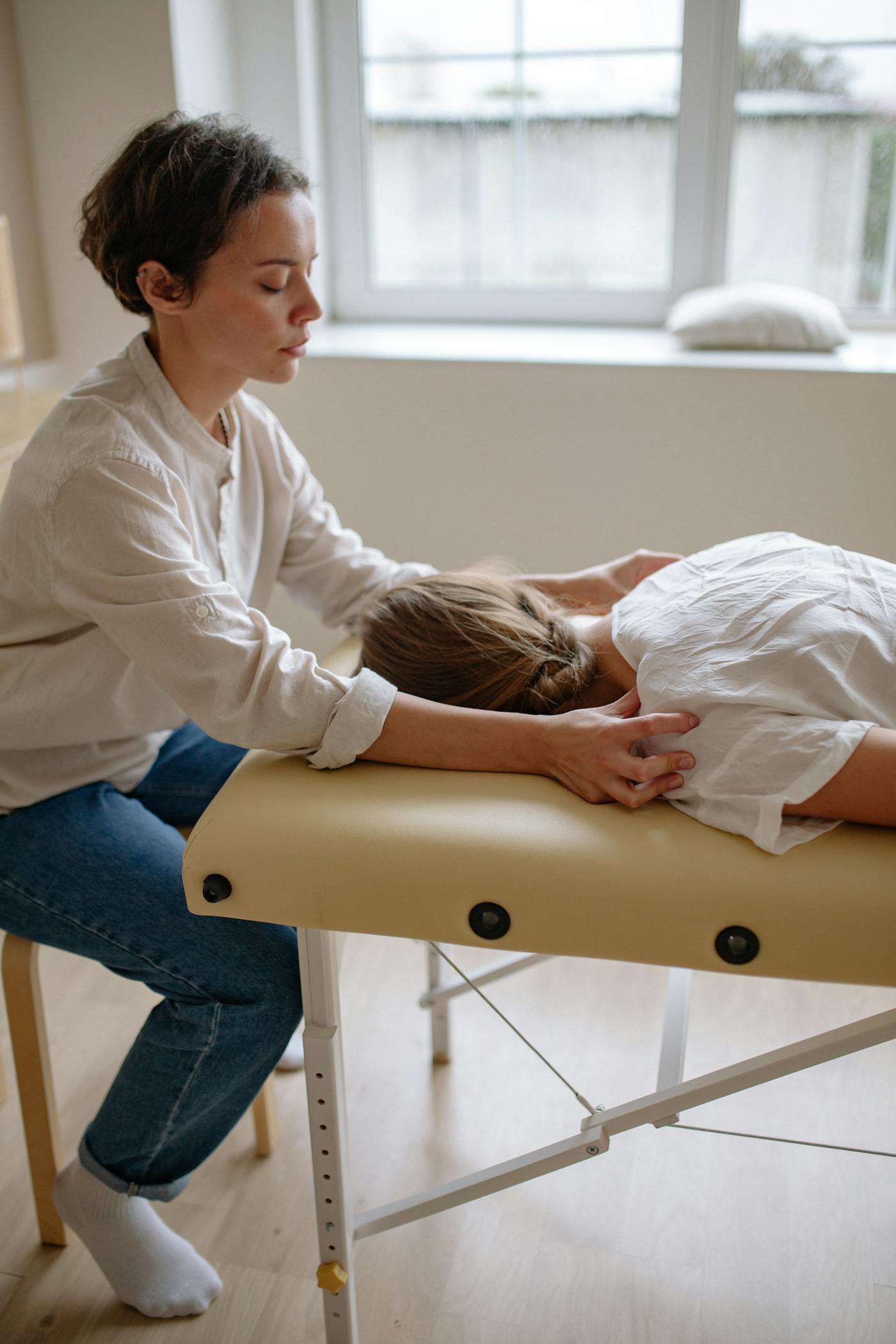 Therapist performing soft tissue therapy on a patient's back